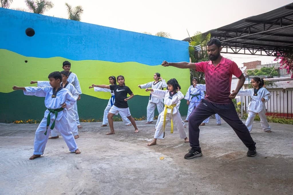Taekwondo class with children practicing stances outdoors at Funplanet Dhanbad