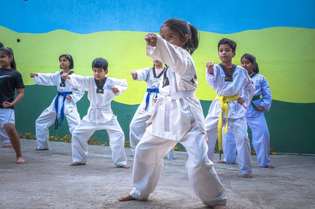 Young Taekwondo students in formation practicing punches at Funplanet